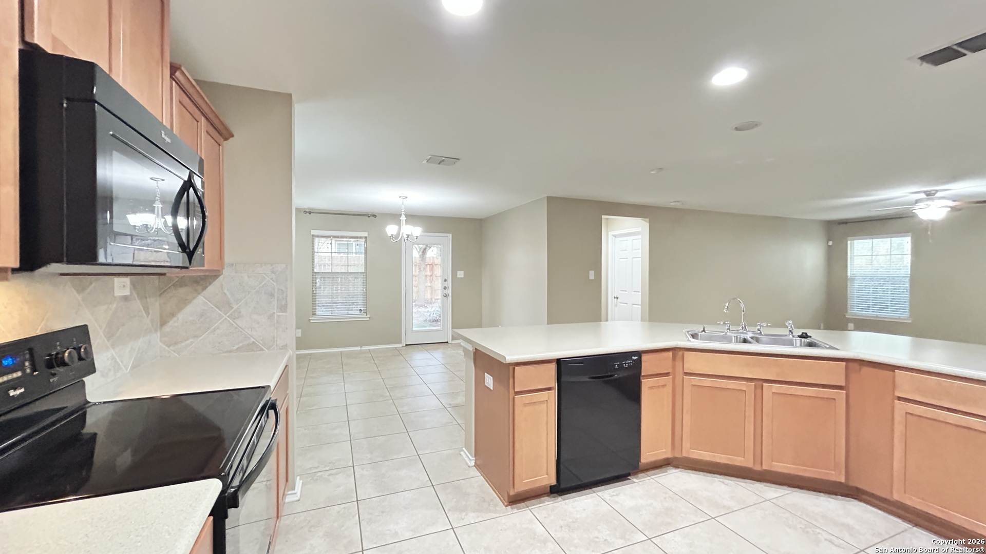 10319 Roadrunner Ridge San Antonio, TX 78245 - Photo 21 of 35 a kitchen with a sink and cabinets