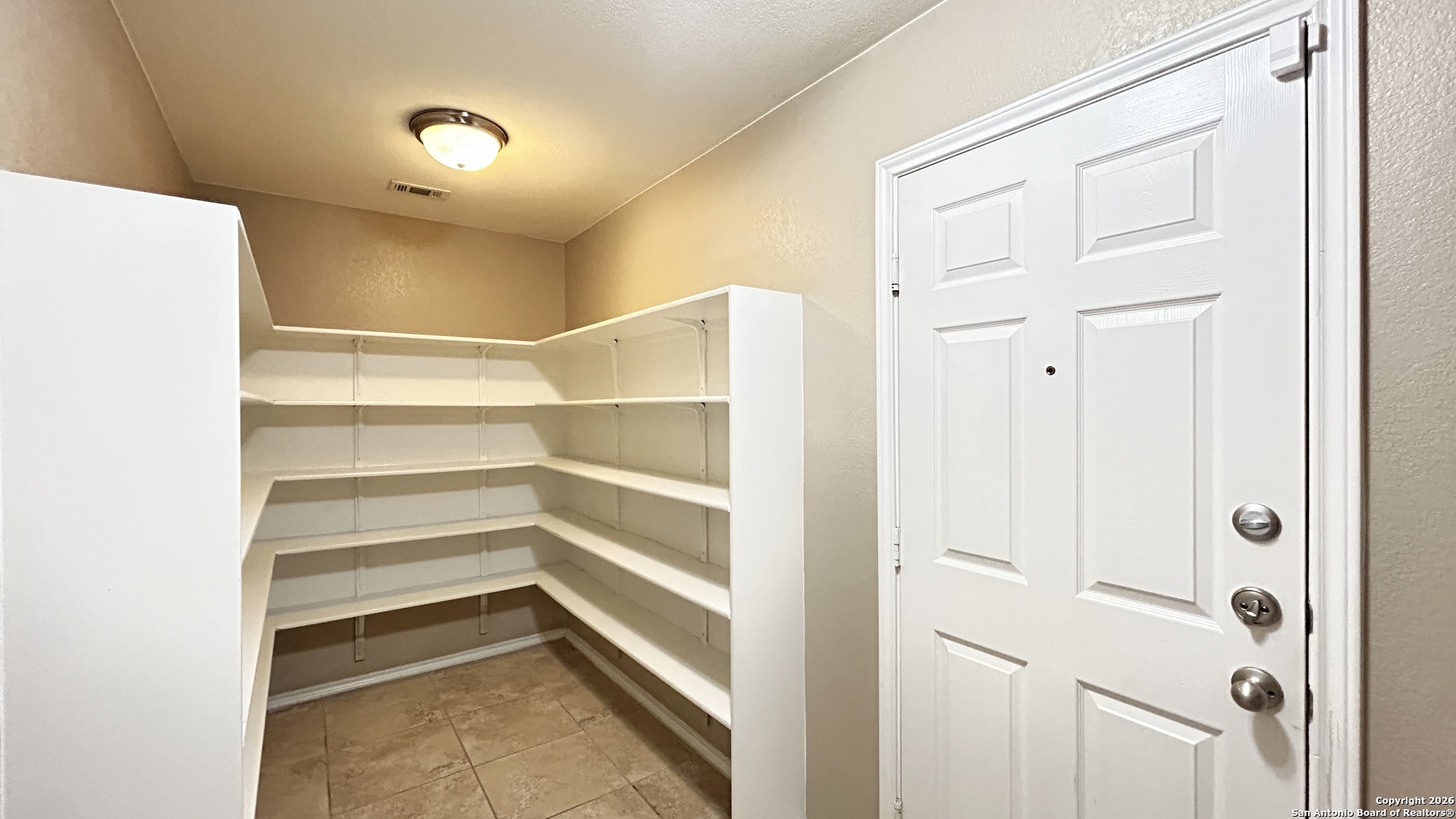 10319 Roadrunner Ridge San Antonio, TX 78245 - Photo 26 of 35 a view of walk in closet with empty racks