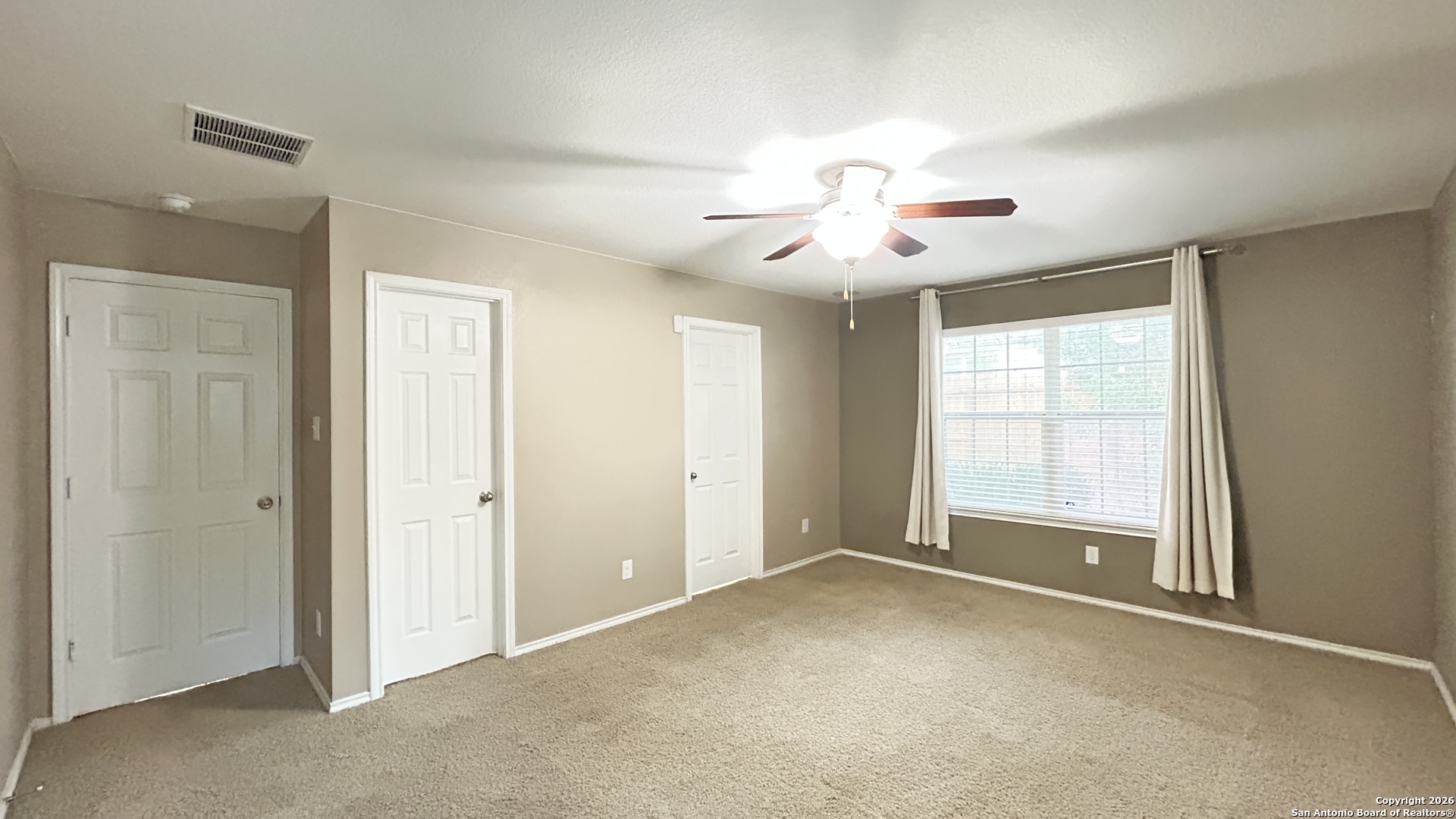 10319 Roadrunner Ridge San Antonio, TX 78245 - Photo 28 of 35 a view of an empty room with chandelier fan and fire place