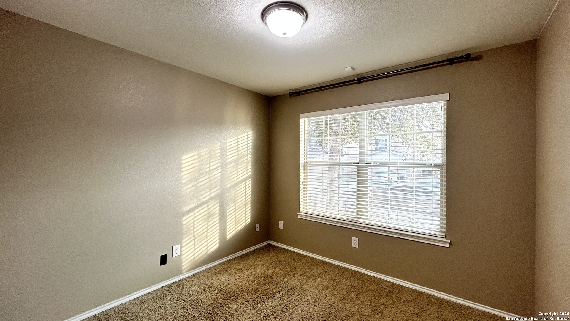 10319 Roadrunner Ridge San Antonio, TX 78245 - Photo 3 of 35 a view of an empty room with a window
