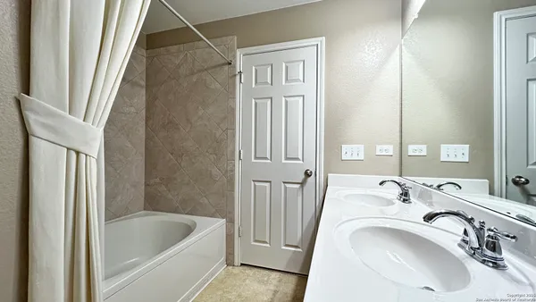 a bathroom with a sink a bathtub and shower