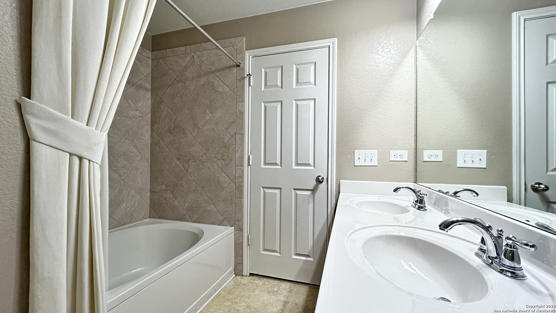 10319 Roadrunner Ridge San Antonio, TX 78245 - Photo 32 of 35 a bathroom with a sink a bathtub and shower