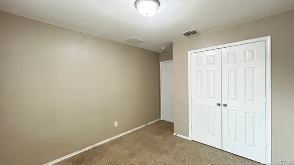 an empty room with closet area