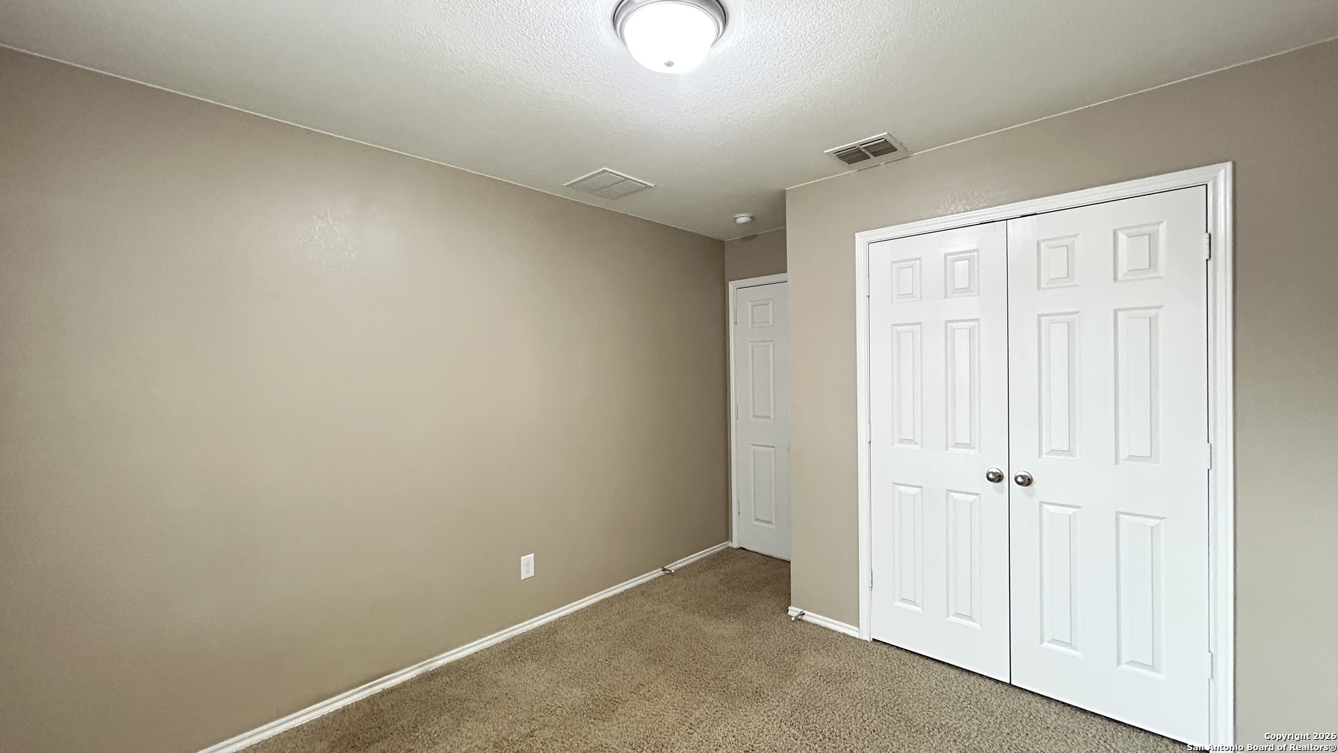 10319 Roadrunner Ridge San Antonio, TX 78245 - Photo 5 of 35 an empty room with closet area