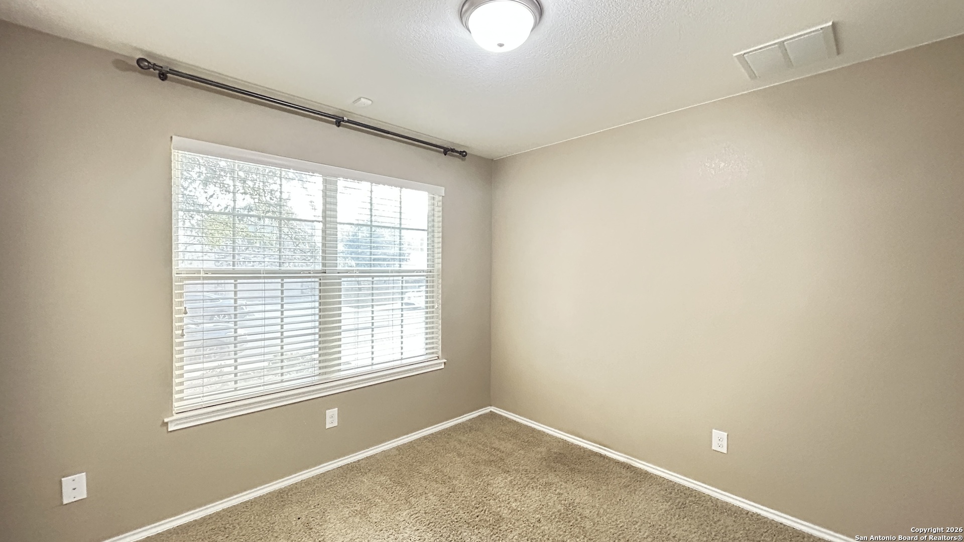10319 Roadrunner Ridge San Antonio, TX 78245 - Photo 6 of 35 a view of an empty room with a window