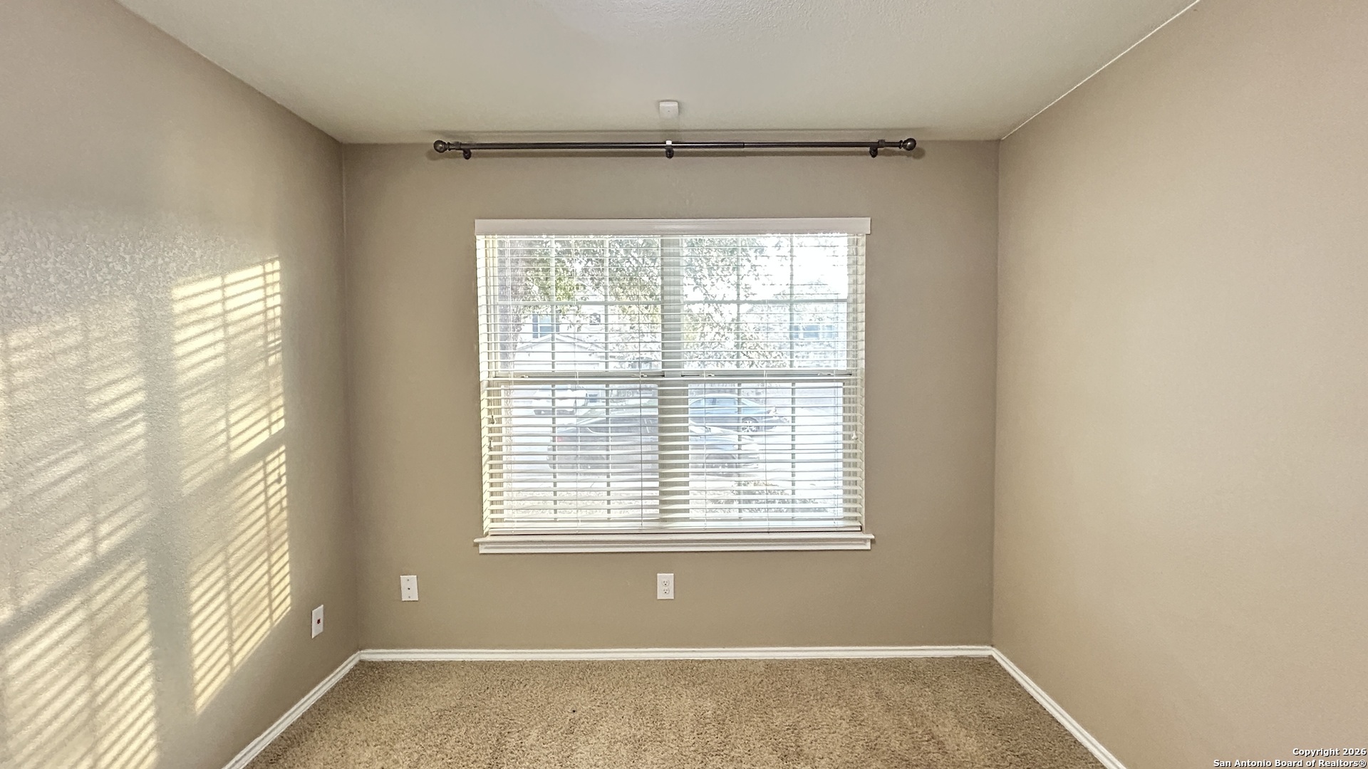 10319 Roadrunner Ridge San Antonio, TX 78245 - Photo 7 of 35 a view of an empty room with a window