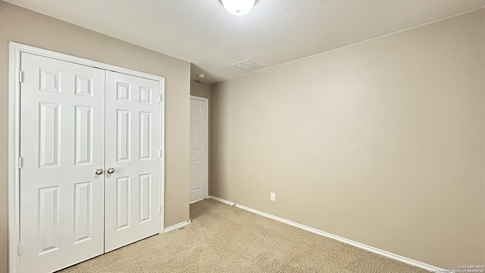 10319 Roadrunner Ridge San Antonio, TX 78245 - Photo 10 of 35 an empty room with windows
