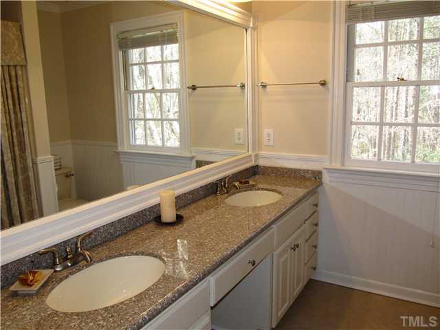 10037 Old Warden Road Raleigh, NC 27615 - Photo 14 of 25 a bathroom with a granite countertop sink and a window