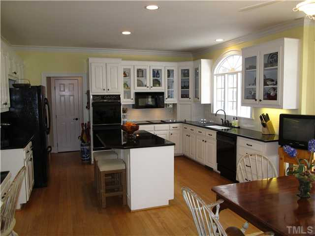 10037 Old Warden Road Raleigh, NC 27615 - Photo 8 of 25 a kitchen with granite countertop a sink appliances and cabinets