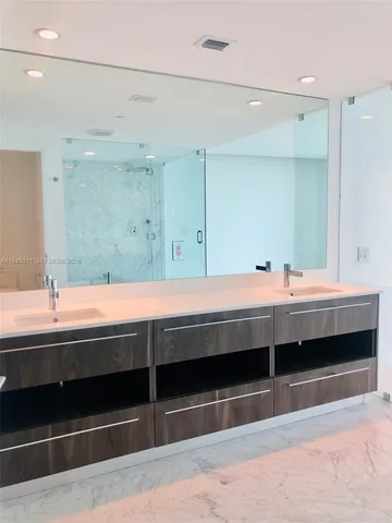 a bathroom with a sink and a large mirror