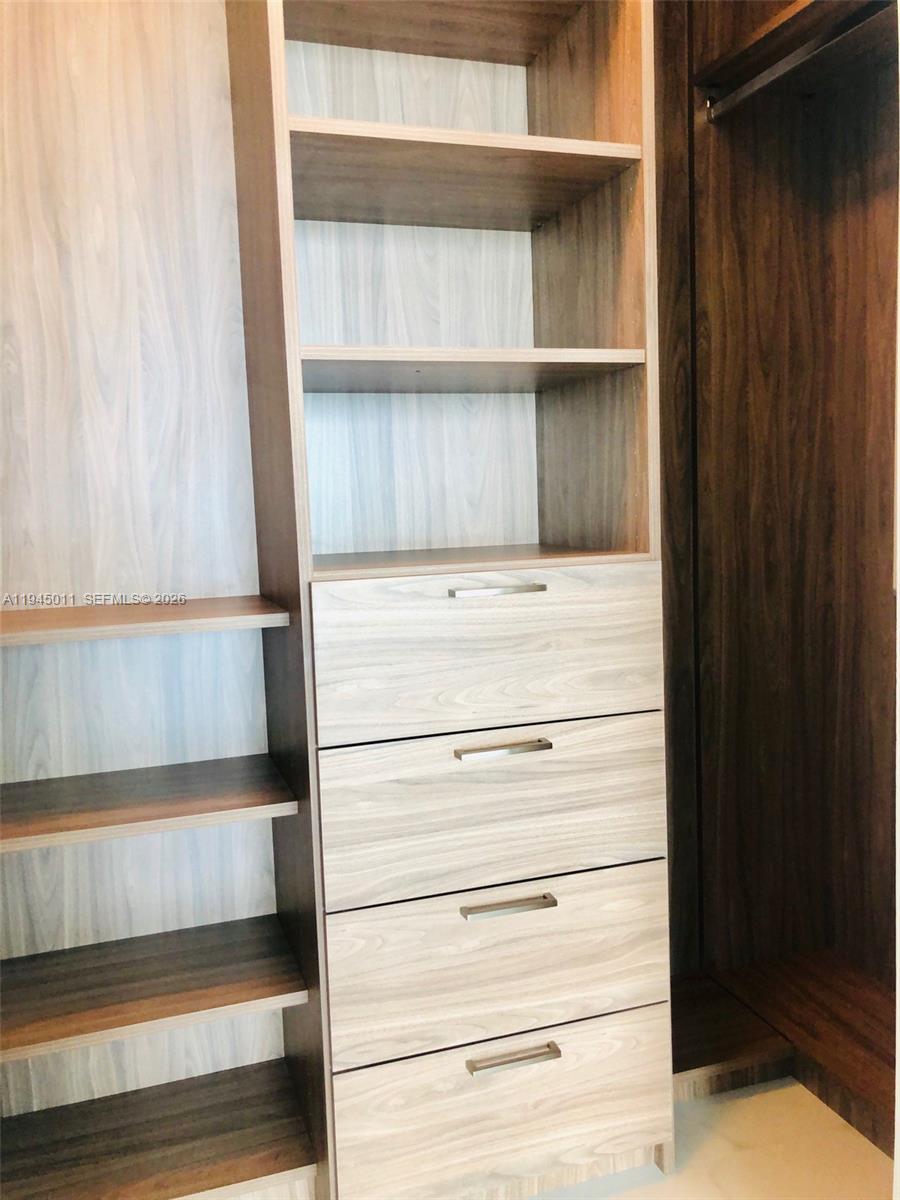 3131 Northeast 7th Avenue, Unit 3305 Miami, FL 33137 - Photo 15 of 44 a view of walk in closet with empty racks