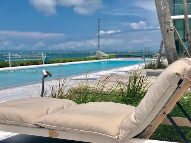 a bedroom with a bed and a chair