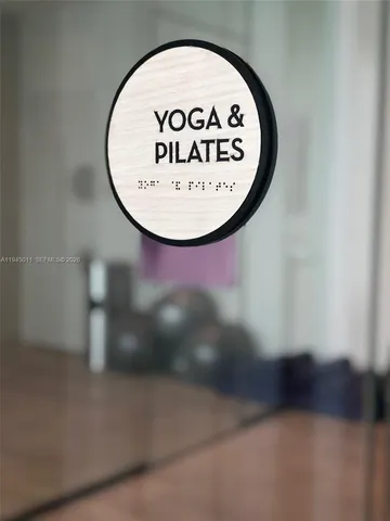 a room with gym equipment and large mirror