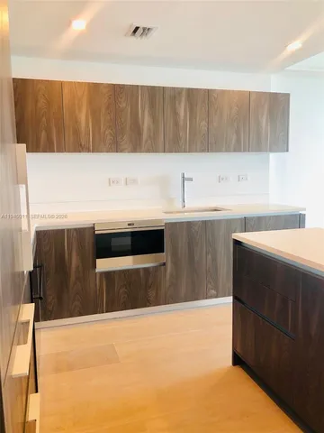 a kitchen with a sink and a stove