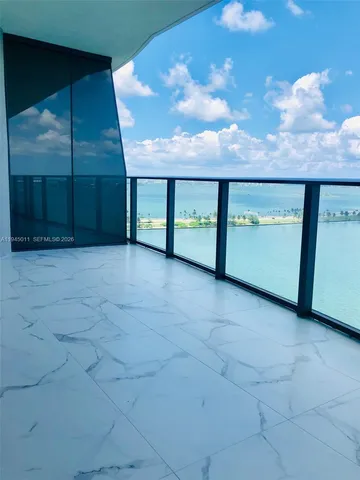a view of an empty room with kitchen
