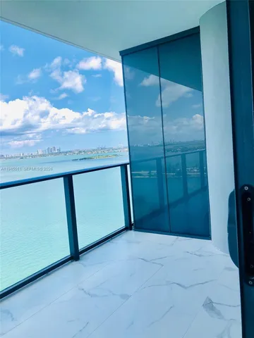 a view of an ocean and city from a balcony