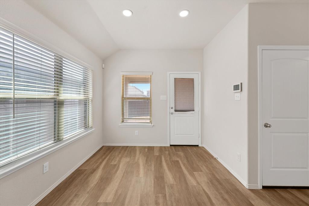 4011 Springfield Lane Crandall, TX 75114 - Photo 12 of 27 a view of an empty room with wooden floor and a window
