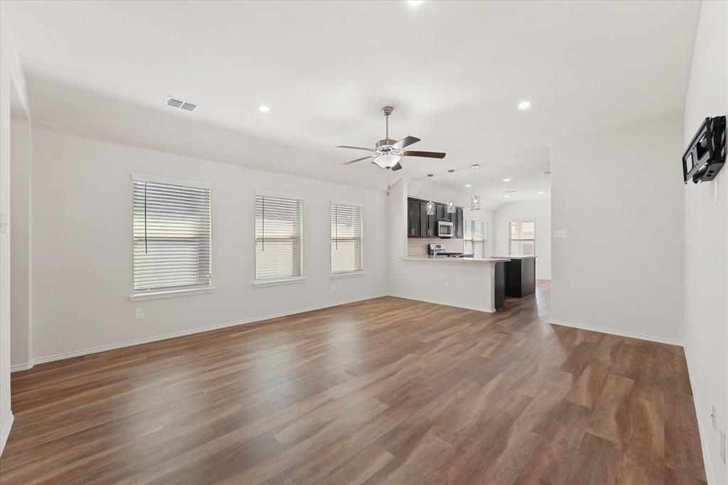 4011 Springfield Lane Crandall, TX 75114 - Photo 13 of 27 a view of an empty room with window and wooden floor
