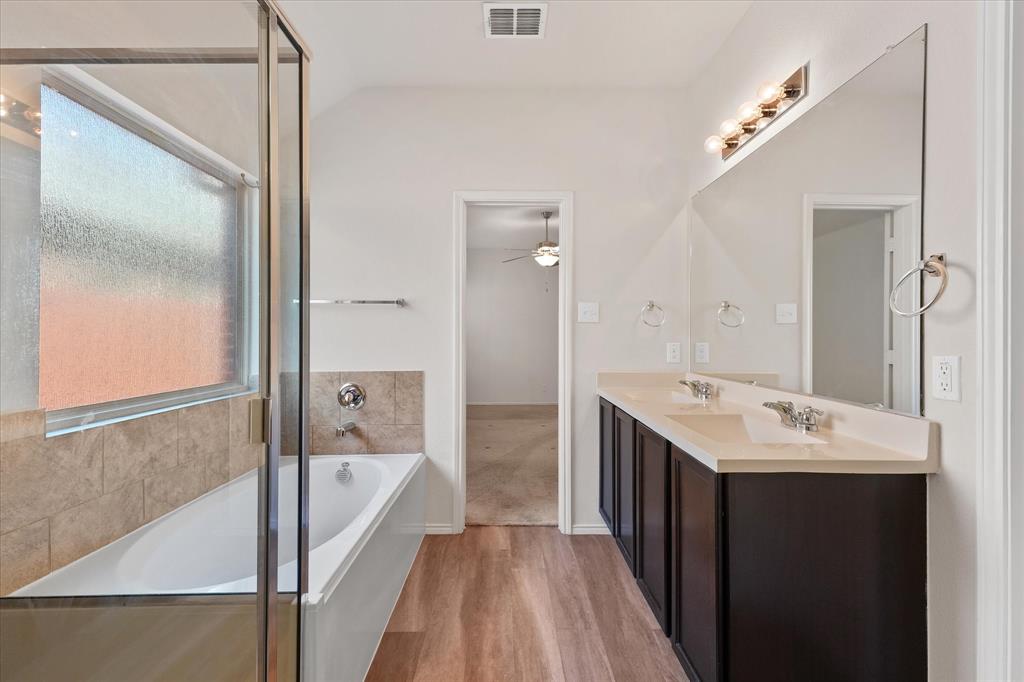 4011 Springfield Lane Crandall, TX 75114 - Photo 18 of 27 a spacious bathroom with a tub sink and mirror