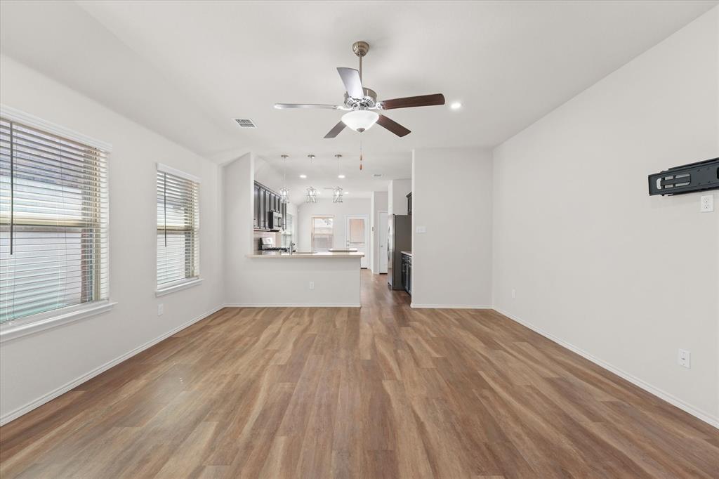 4011 Springfield Lane Crandall, TX 75114 - Photo 23 of 27 a view of an empty room with window and wooden floor