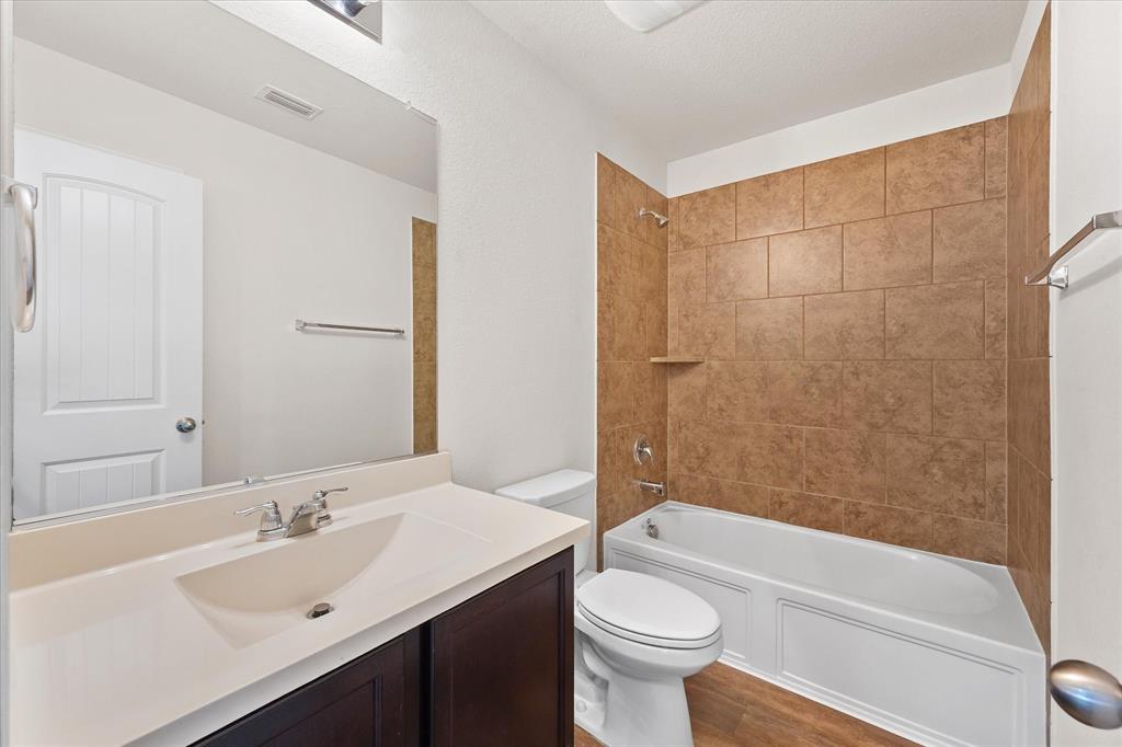 4011 Springfield Lane Crandall, TX 75114 - Photo 7 of 27 a bathroom with a sink a toilet and a bathtub