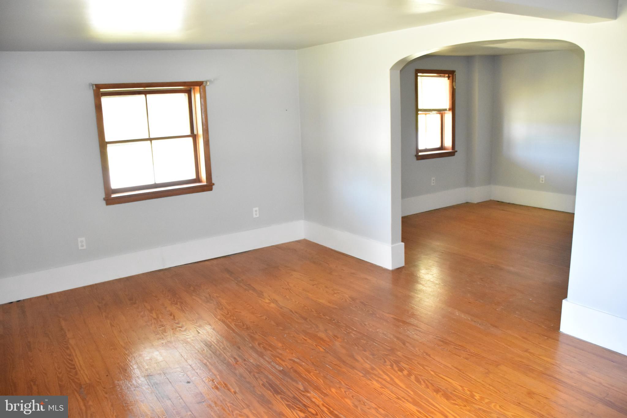 1362 New Road Orrtanna, PA 17353 - Photo 21 of 28 an empty room with wooden floor and windows