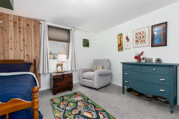 a bedroom with furniture and a window