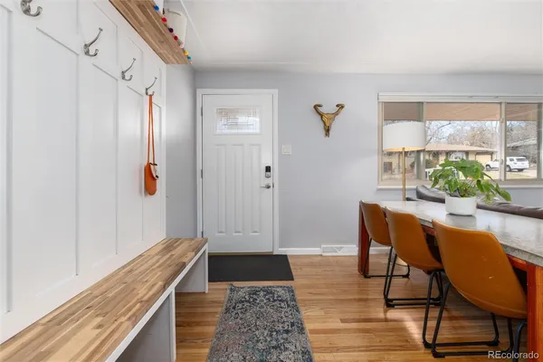 a view of a room with furniture and wooden floor