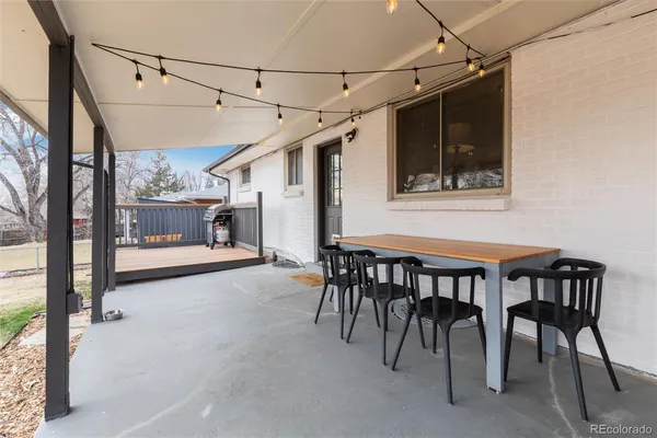 a dining room with a wooden table and chairs