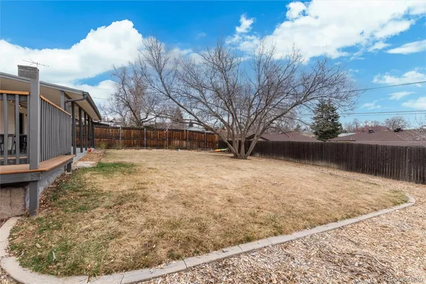 a view of yard covered with snow in front of house