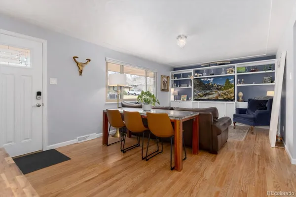 a dining room with furniture and wooden floor