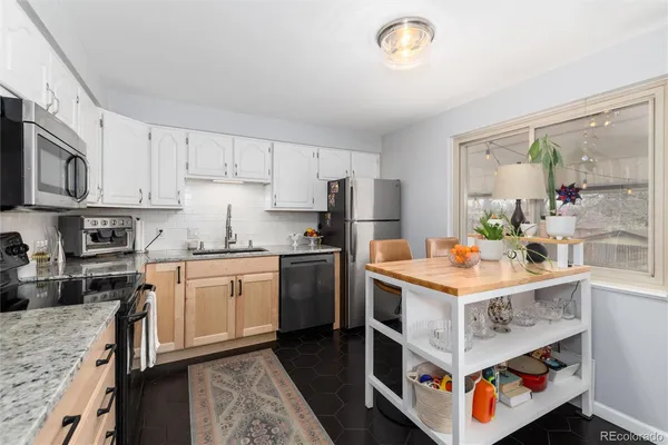 a kitchen with a stove top oven sink and cabinets