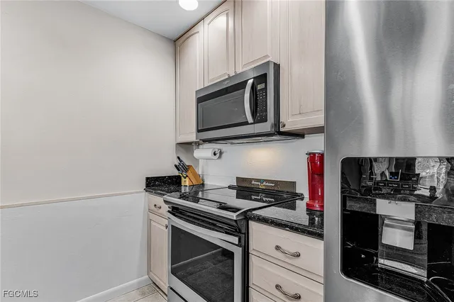 a kitchen with stainless steel appliances granite countertop a stove microwave and sink