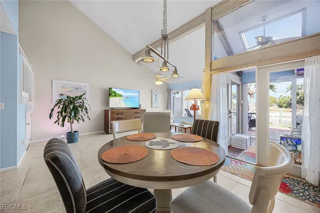 a view of a patio with a table and chairs under an umbrella