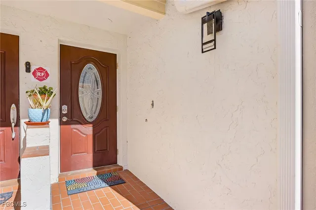 a living room with furniture a flat screen tv and a chandelier