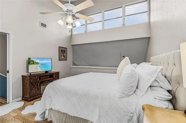 a bedroom with a bed and a chandelier