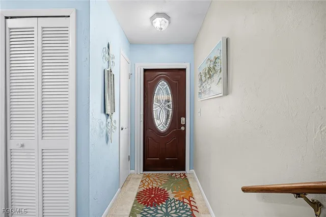 a living room with furniture a flat screen tv and a large window