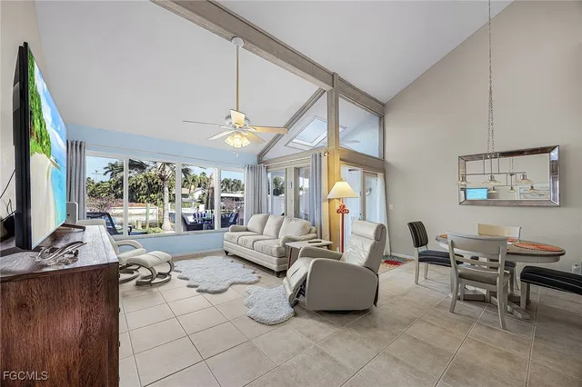 a kitchen with stainless steel appliances granite countertop a refrigerator a stove and a sink with wooden floor