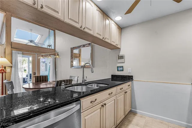 a kitchen with granite countertop a sink and cabinets