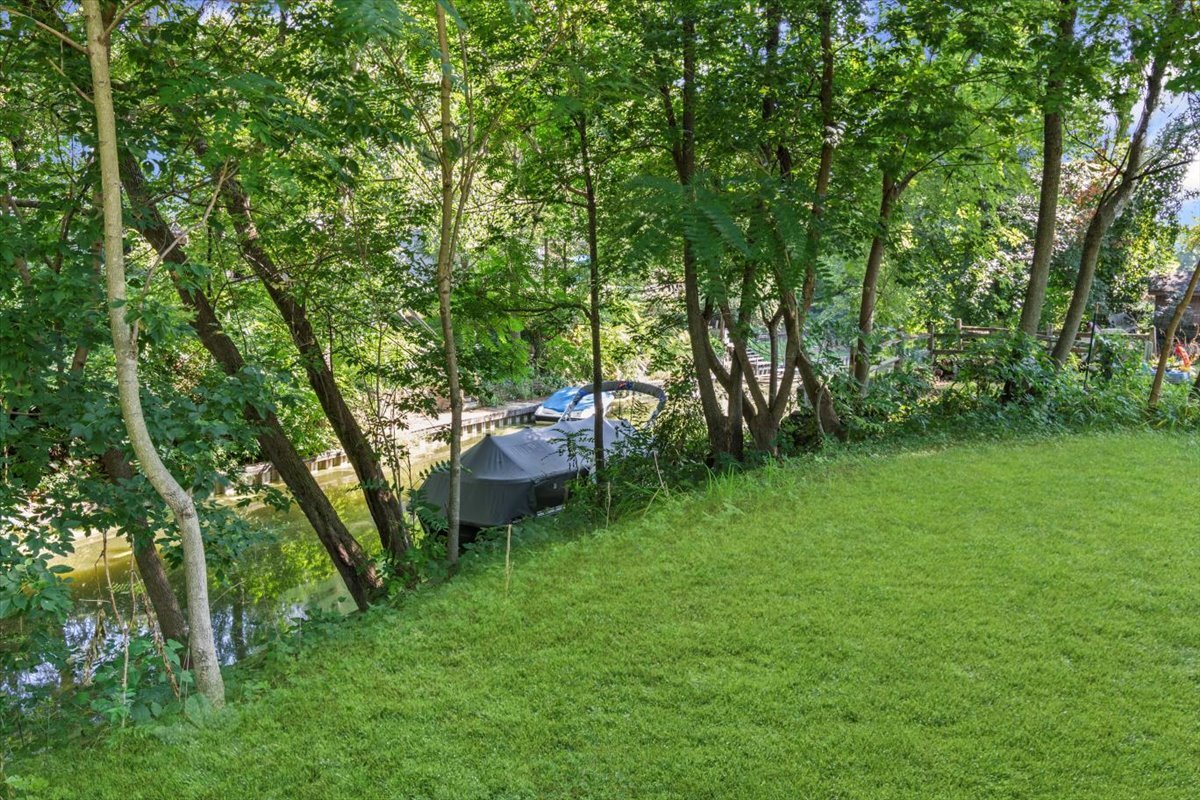 2016 Grove Lane Cary, IL 60013 - Photo 15 of 18 a view of a backyard with a garden and trees