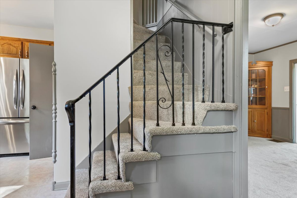 2016 Grove Lane Cary, IL 60013 - Photo 6 of 18 a view of staircase with a rug and a window
