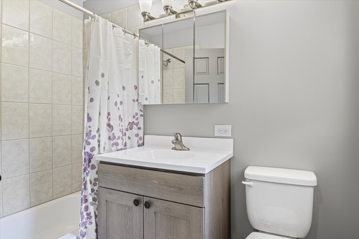 2016 Grove Lane Cary, IL 60013 - Photo 9 of 18 a bathroom with a sink a toilet and shower