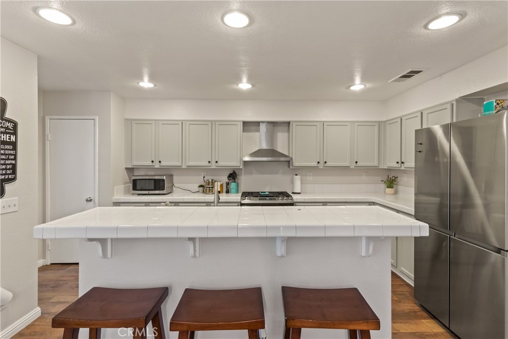 2614 Bellevue Way Palmdale, CA 93550 - Photo 11 of 28 a kitchen with a sink cabinets and refrigerator