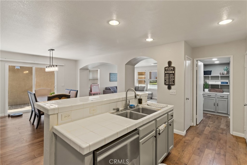 2614 Bellevue Way Palmdale, CA 93550 - Photo 12 of 28 a kitchen with a sink a stove and chairs