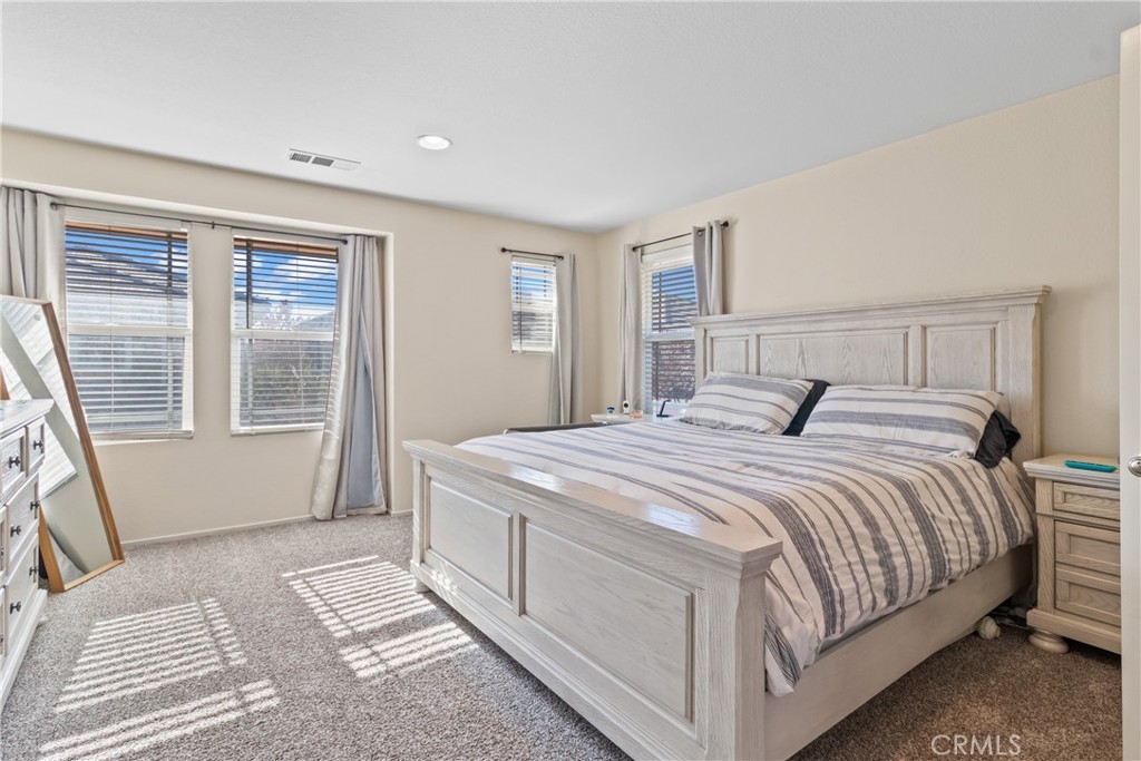 2614 Bellevue Way Palmdale, CA 93550 - Photo 16 of 28 a bedroom with a large bed and a window