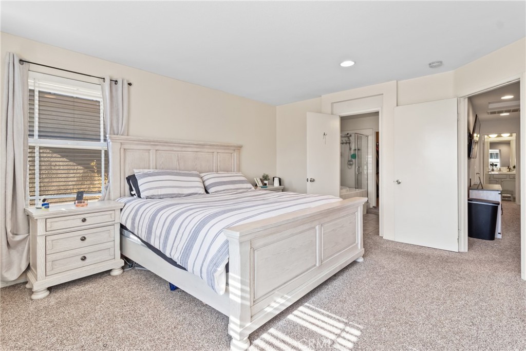 2614 Bellevue Way Palmdale, CA 93550 - Photo 17 of 28 a spacious bedroom with a bed and a cabinets