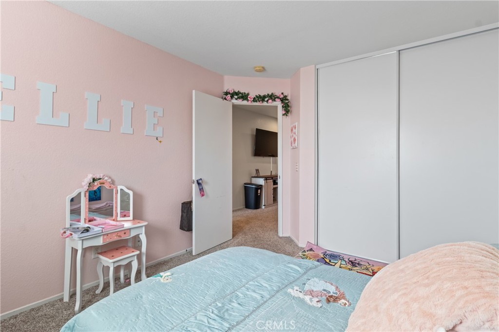 2614 Bellevue Way Palmdale, CA 93550 - Photo 20 of 28 a bedroom with a bed and a television