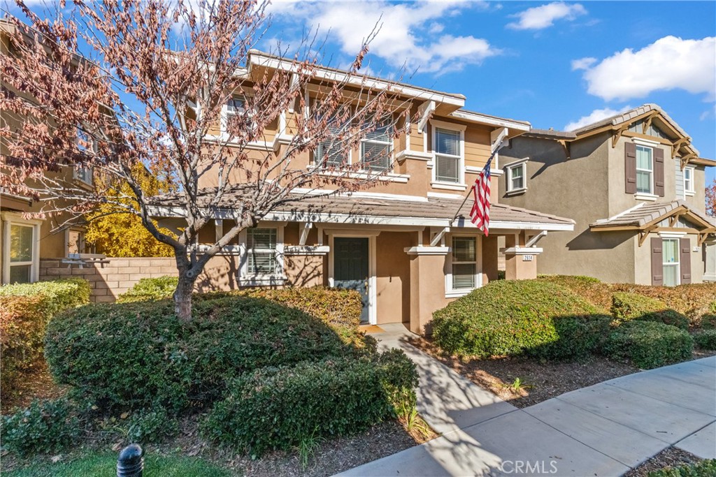 2614 Bellevue Way Palmdale, CA 93550 - Photo 2 of 28 a view of a white house with a large tree and plants