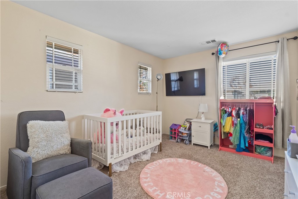 2614 Bellevue Way Palmdale, CA 93550 - Photo 22 of 28 a view of a bedroom with furniture and windows