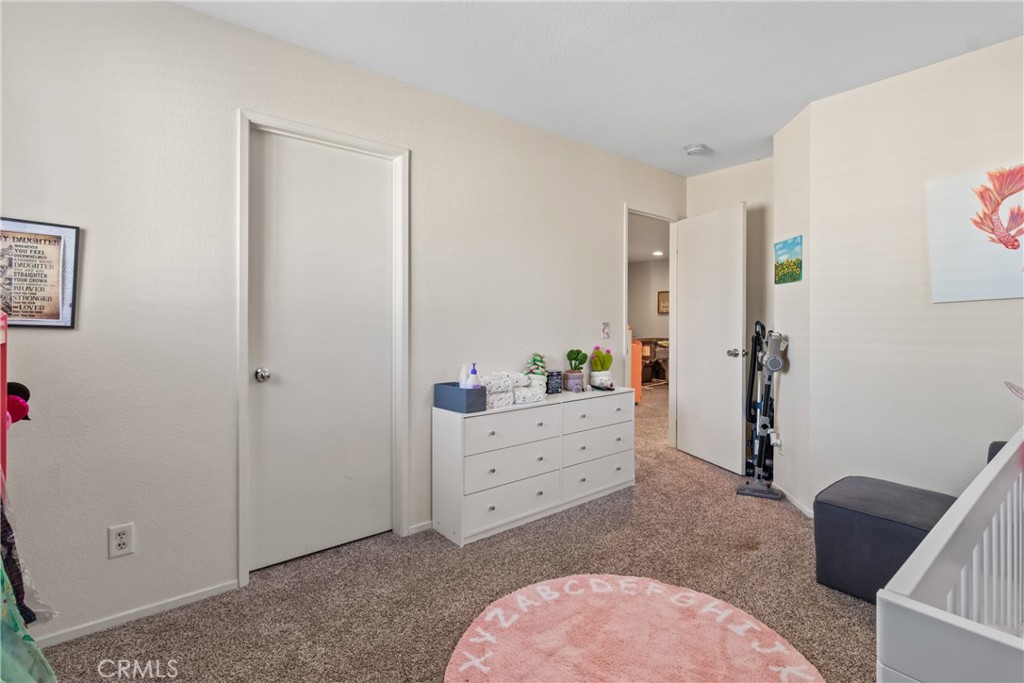 2614 Bellevue Way Palmdale, CA 93550 - Photo 23 of 28 a bed room with a bed and a dresser